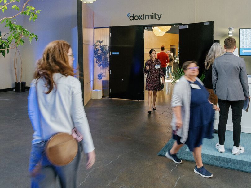 Several individuals walking through a demonstration room during the Doximity Conference